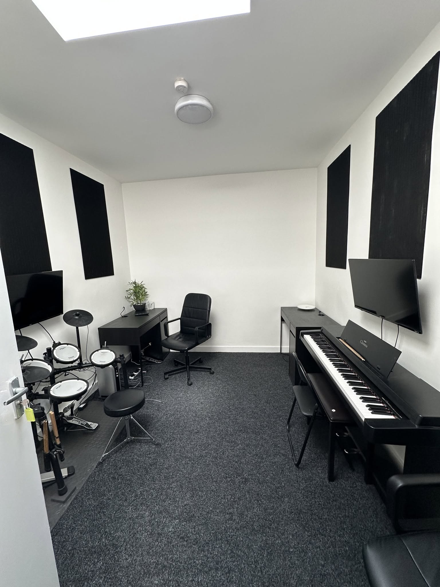 Academy teaching room with a digital piano and electronic drum kit
