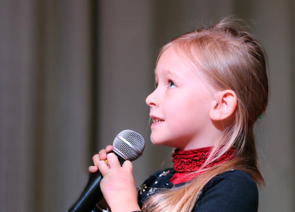 Girl Holding Black Dynamic Microphone While Looking Above